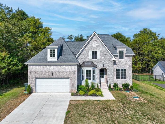 Front elevation, limewashed brick with a side-entry garage
