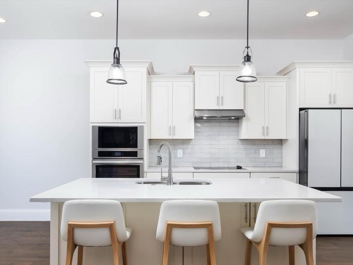 Quartz island seats three under school-house pendants