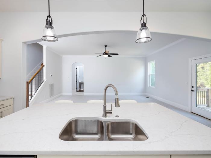 Undermount double sink faces the living room
