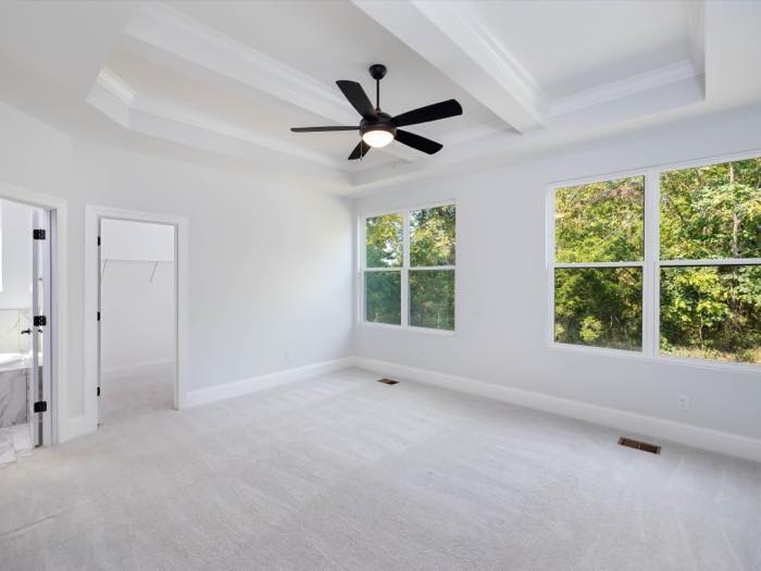 Primary bedroom on the main level, coffered ceiling