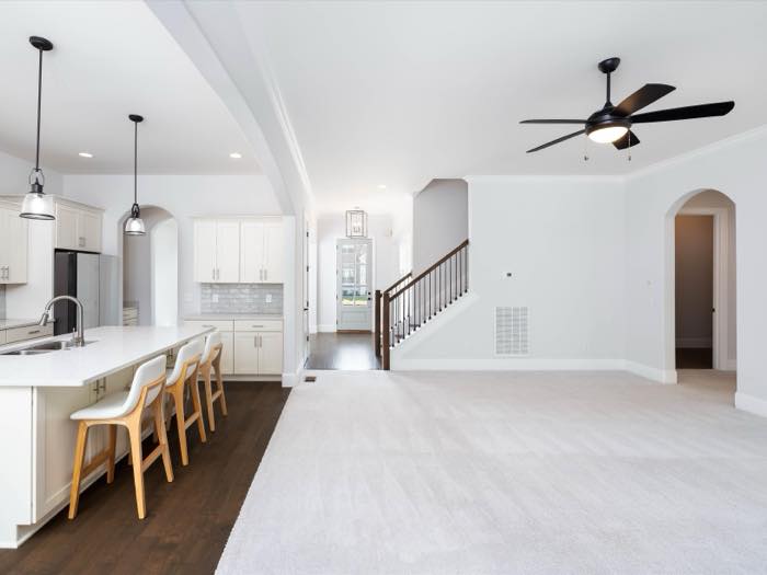 The full main-level sweep: living, kitchen, stair