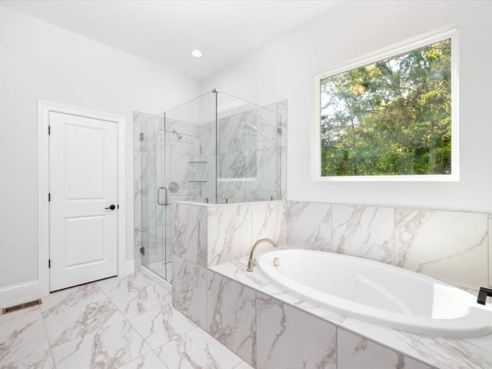 Primary bath: soaking tub and a glass corner shower