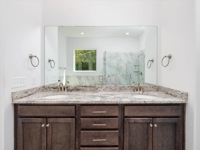 Granite double vanity with framed mirror