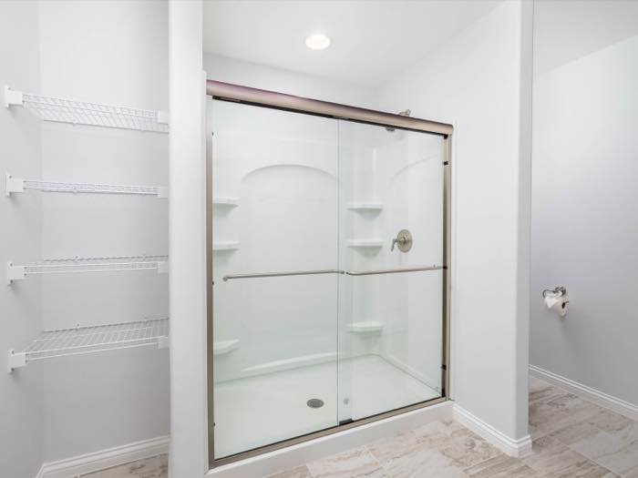 Shower and linen shelving side by side